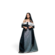 Modelo vestindo vestido de gala Dani Levine preto e prata com corpete brilhante, decote escultural e saia volumosa.